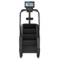 Black commercial stair climber with digital display console, handrails, and stepped tread on white background