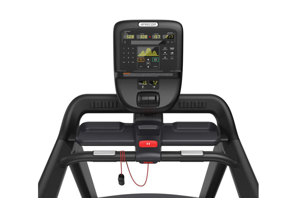 Black Precor TRM 531 treadmill with digital console displaying metrics, red emergency stop button, and attached headphone cor