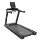 Black commercial treadmill with digital console, handrails, and wide running deck on white background