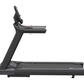 Black motorized treadmill with upright console and handrails, featuring wide running belt and digital display on white backgr