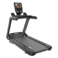 Black commercial treadmill with digital console display, handrails, and running deck on white background