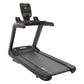 Black motorized treadmill with digital display console, handrails, and wide running deck on white background