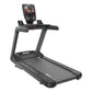 Black commercial treadmill with digital console, handrails, and running deck on white background