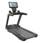 Black commercial treadmill with digital console display and touchscreen, handrails, and running deck on white background