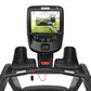 Precor TRM 700 treadmill with black frame, digital touchscreen display showing welcome screen, and red emergency stop button,