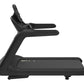 Black commercial treadmill with dual handles and textured running surface on white background