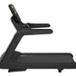 Black commercial treadmill with dual handrails, digital console display, and textured running deck on white background