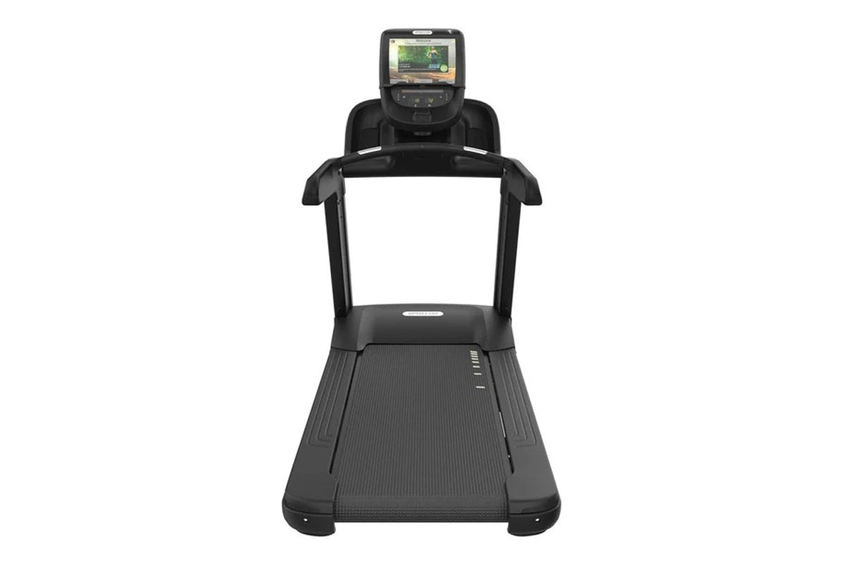 Black commercial treadmill with digital display console showing workout screen, textured running belt, and handrails on white
