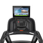 Black Precor treadmill with touchscreen console displaying fitness interface, green progress bar, and digital readout showing