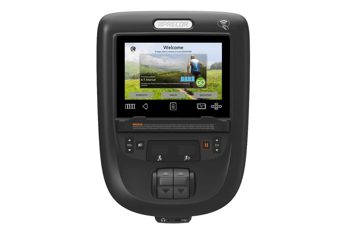 Black Precor exercise bike console displaying welcome screen with touchscreen, control buttons, and orange accent details on 