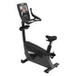 Black upright exercise bike with digital console display, handlebar grips, padded seat, and stabilizing base on white backgro
