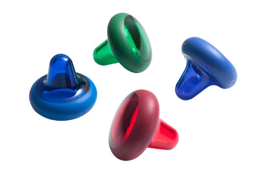 Four colorful massage balls in blue, green, red, and burgundy with textured knobble surfaces, displayed on white background