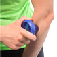 Blue handheld massage ball held in hand against arm, worn by model in green shirt