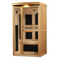 Natural wood far infrared sauna cabin with glass door panels, interior black accents, and control panel, seated against white