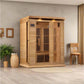 Cedar wood 3-person infrared sauna with black interior vents and digital control panel in modern room setting