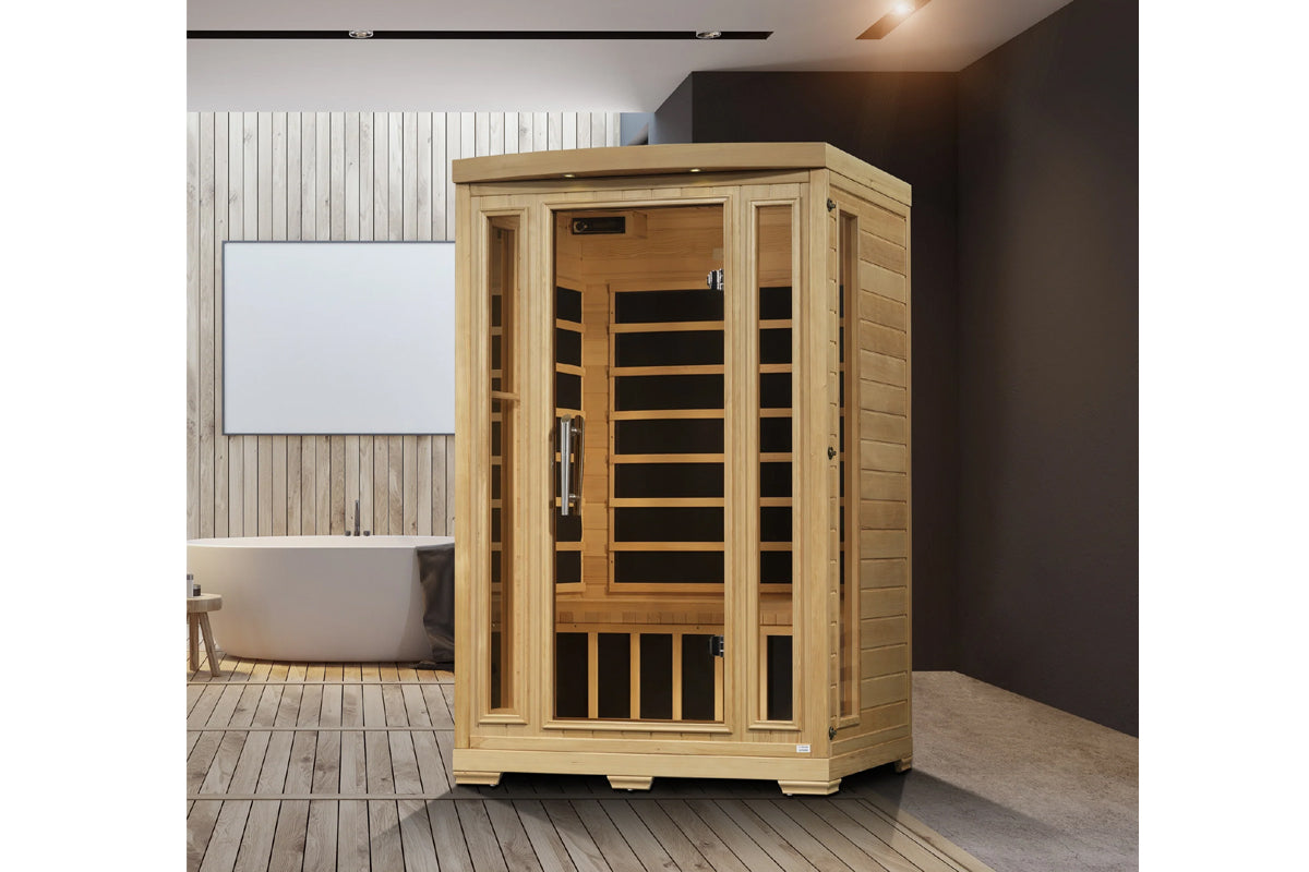 Natural cedar wood sauna cabin with glass front door and black interior benches, shown in spa bathroom setting