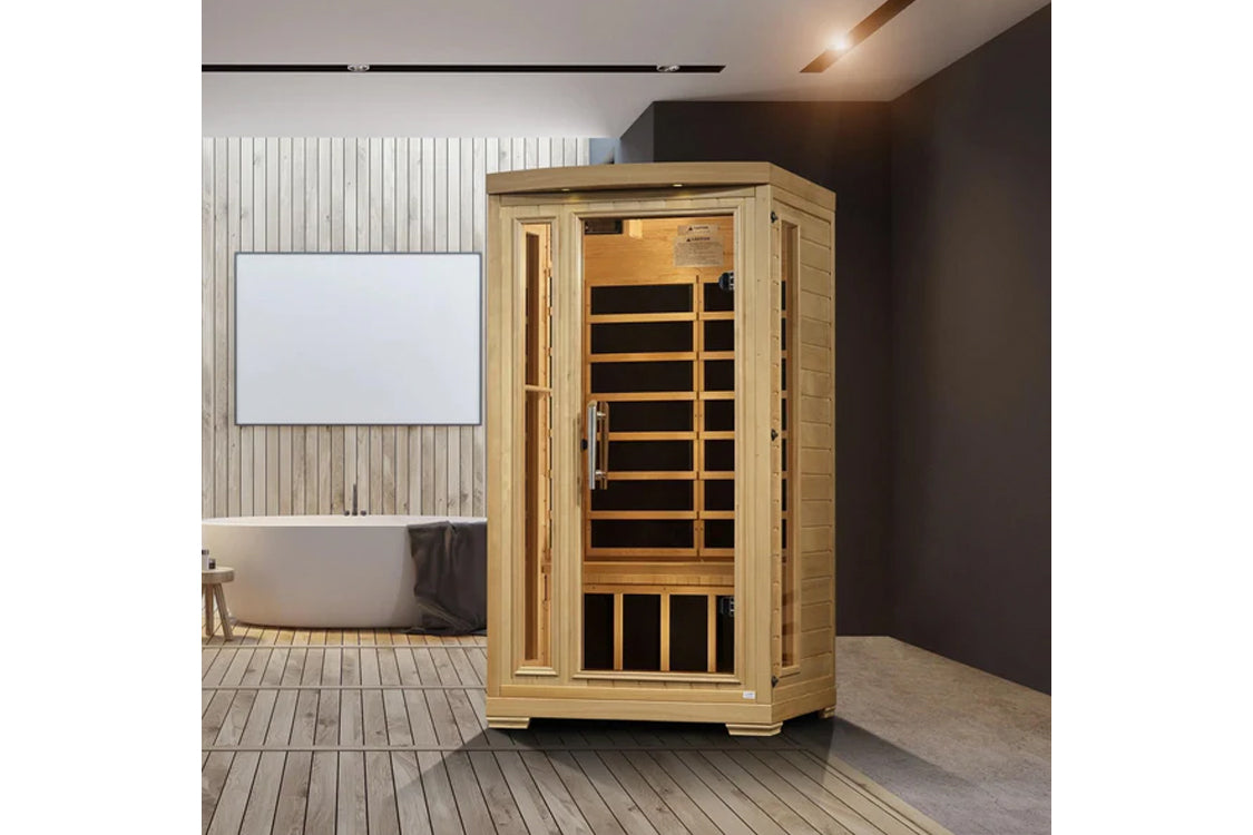Natural wood infrared sauna cabin with glass door and wooden bench interior, displayed in modern bathroom setting