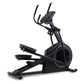 Black elliptical machine with dual handles, foot pedals, and digital display console on white background