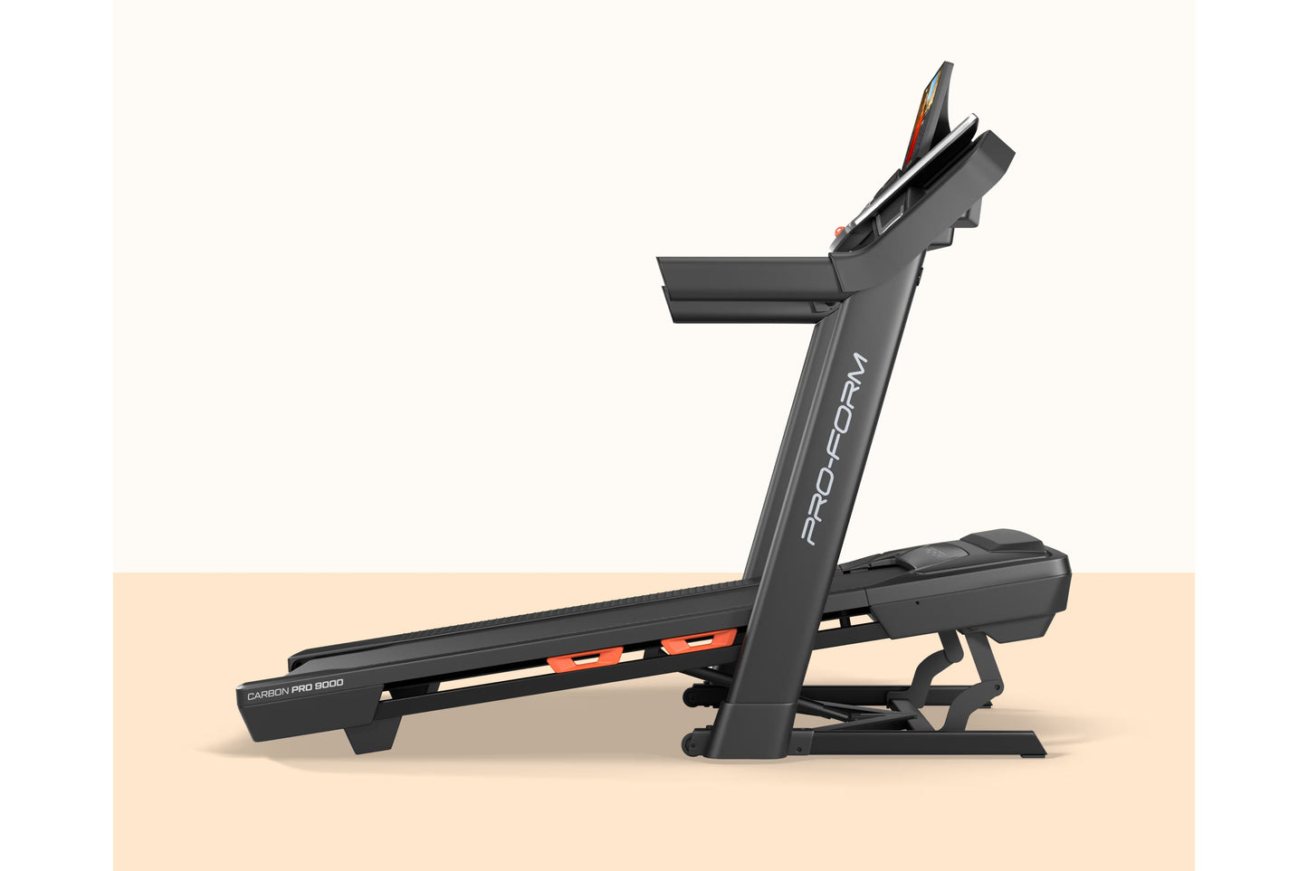 ProForm Carbon Pro 9000 black treadmill with orange accents and digital display on tan background