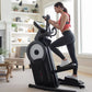 Woman wearing pink sports top and black leggings using black and white ProForm elliptical machine in bright home gym with fir