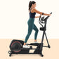 Woman using black elliptical machine with red accents, wearing navy sports bra and teal leggings, on beige background