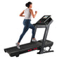 Woman running on black ProForm Trainer 1000 treadmill with touchscreen display, wearing gray tank top and navy leggings