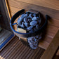 Black and blue safety railing with perforated design filled with blue stones, displayed on wooden deck