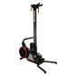 Black and red SKI-ROW Air+PWR rowing machine with tall vertical frame, red-trimmed wheel, and extended footrest on white back