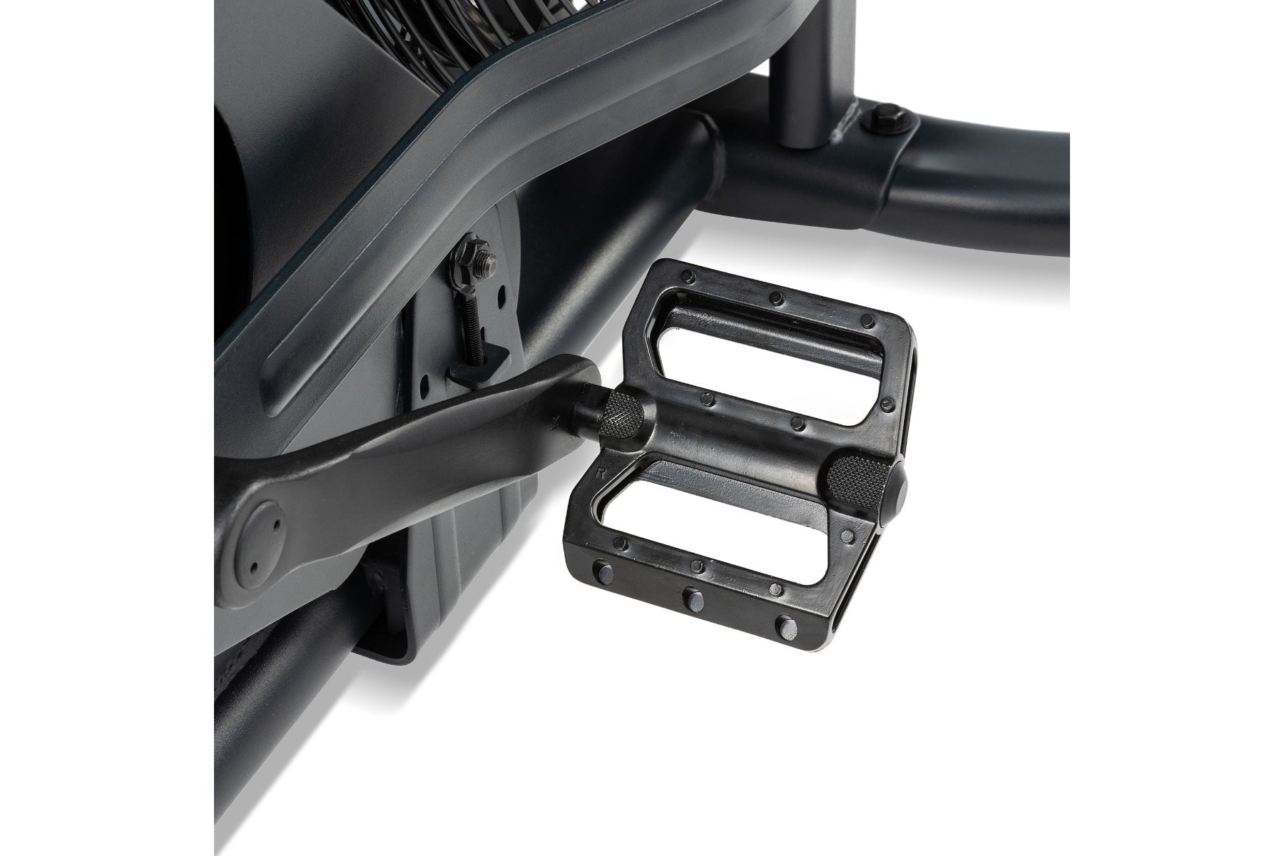 Black metal pedals with textured grip surface attached to exercise bike frame on white background