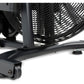 Black stationary exercise bike with curved frame, ribbed fan wheel cage, and rolling casters on white background