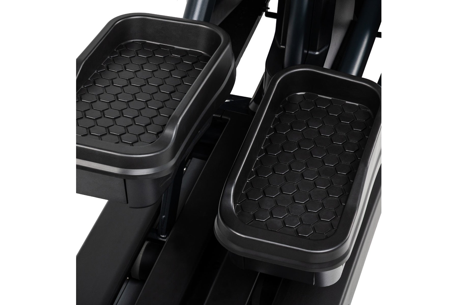 Black hexagonal-patterned foot pedals on Spirit CE1000ENT elliptical machine, shown on white background