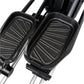 Black pedals with ridged surface detail on silver elliptical machine frame, close-up view