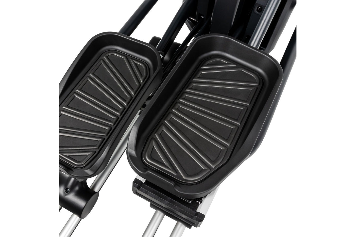 Black pedals with ridged surface detail on silver elliptical machine frame, close-up view