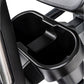 Black cup holder attached to elliptical machine frame with mounting bracket
