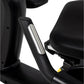 Black recumbent exercise bike with padded seat and handlebar featuring textured grip and silver accent bar detail on white ba