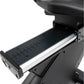 Black recumbent exercise bike with extended foot pedal platform, numbered measurement markings, and silver aluminum frame det