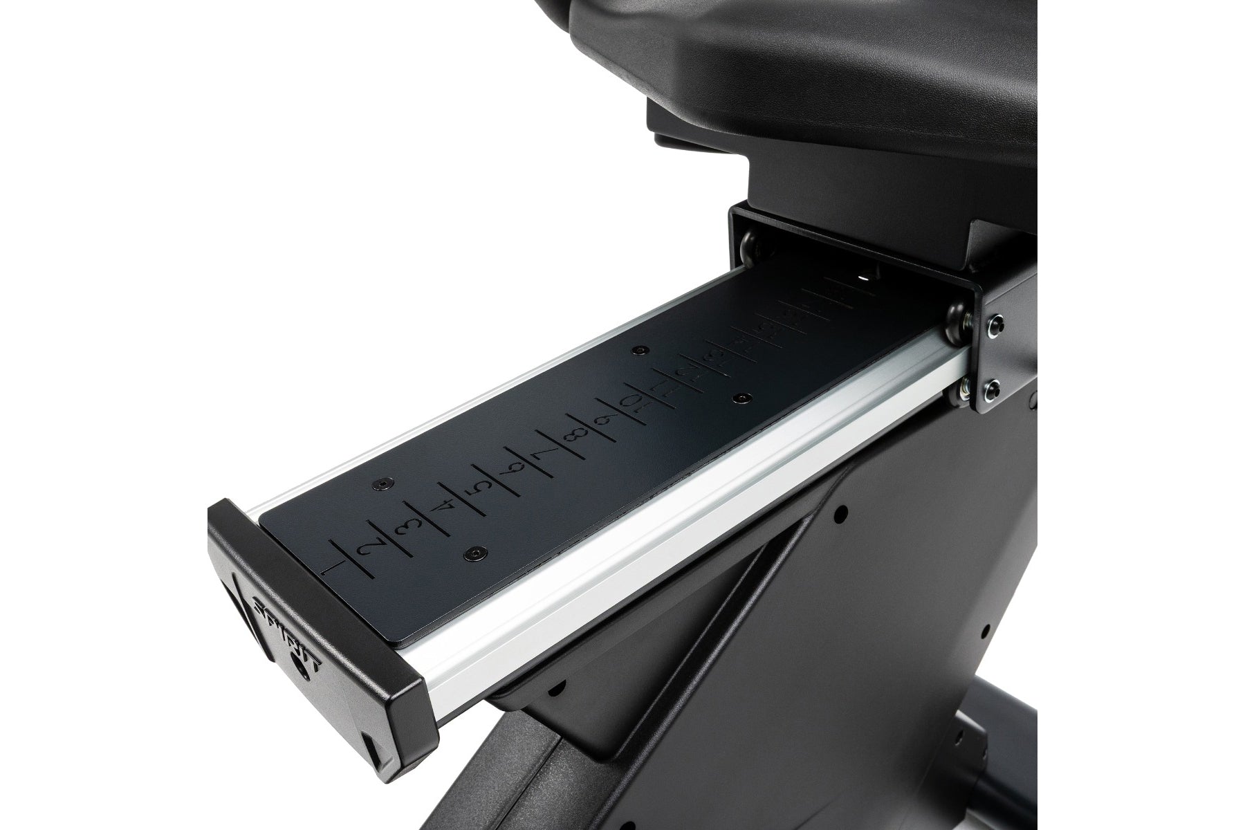 Black recumbent exercise bike with extended foot pedal platform, numbered measurement markings, and silver aluminum frame det