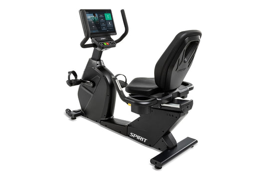 Spirit CR1000ENT black recumbent exercise bike with digital display console, padded seat, and foot pedals on white background
