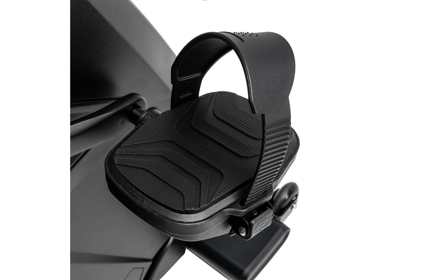 Black pedal with textured ribbed surface and adjustable foot strap on stationary bike, front view