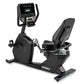 Spirit CR800 black recumbent exercise bike with digital display console, padded seat, and footrest on white background