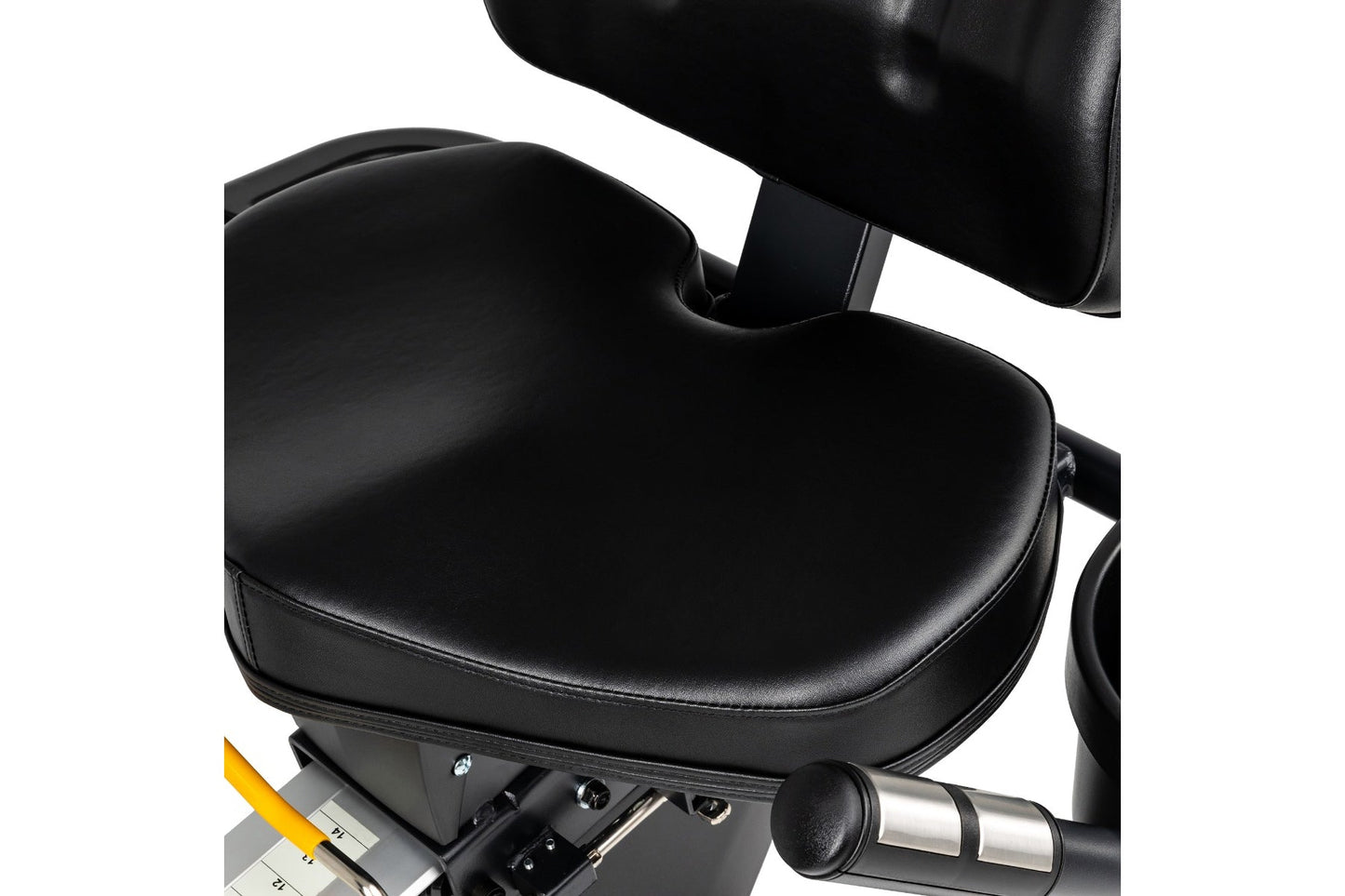 Black leather seat and backrest on recumbent exercise bike with yellow resistance lever and chrome handlebar grip visible