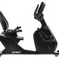 Black Spirit CR900 recumbent exercise bike with padded seat, adjustable armrests, and digital display console on white backgr