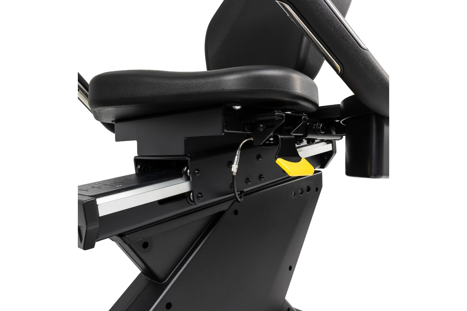 Black recumbent exercise bike with padded seat, foot pedals with yellow accent, and adjustable armrests on white background