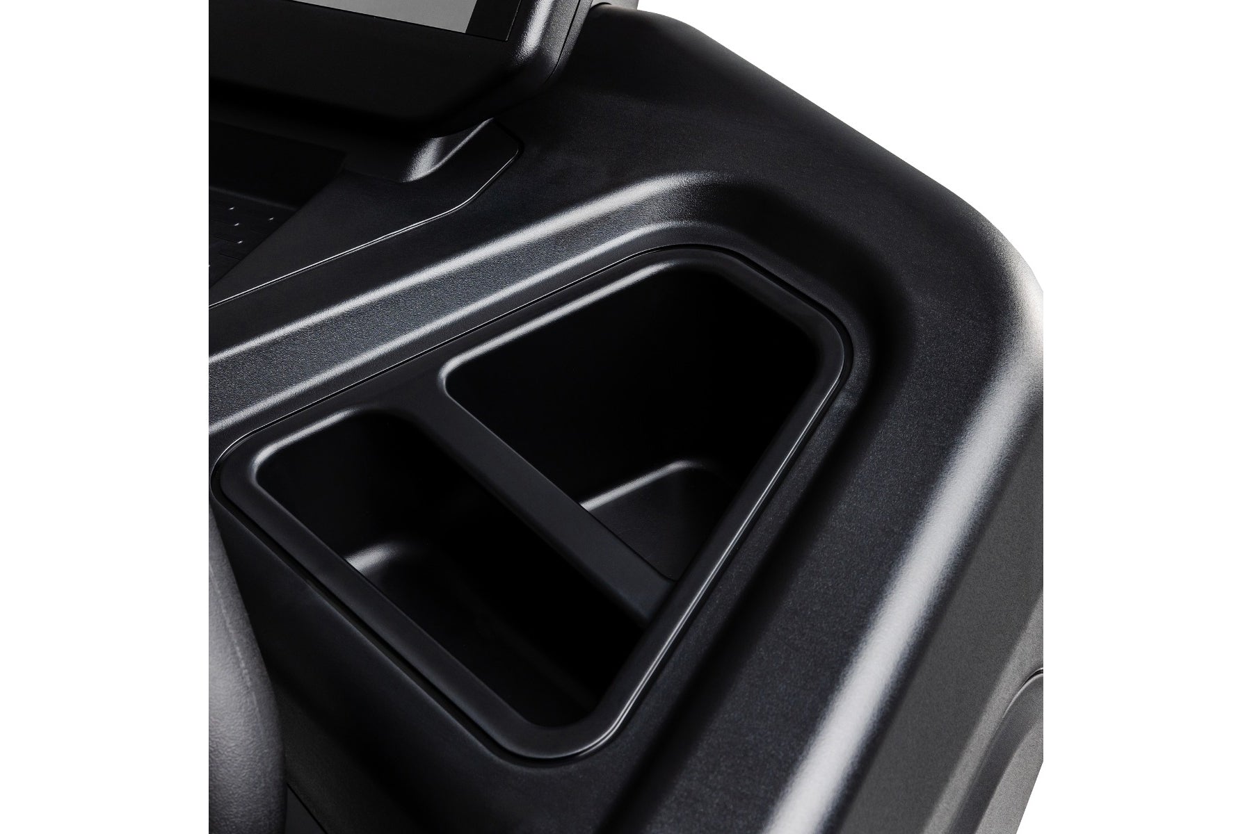 Black plastic cup holders detail on treadmill console, close-up view