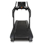 Black commercial treadmill with digital console display, wide slatted belt, dual handrails, and sturdy frame on white backgro