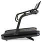 Spirit CTSBS900 black curved treadmill with slat belt, angled console, and dual handles on white background