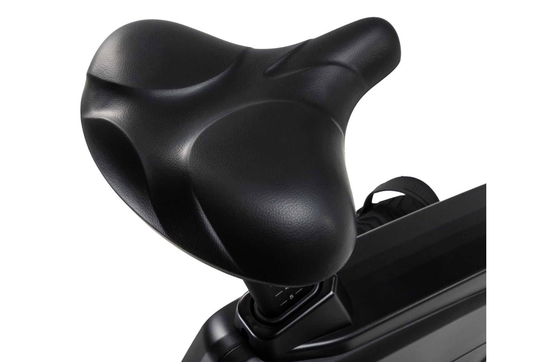 Black contoured seat with ergonomic design on stationary upright bike, close-up view