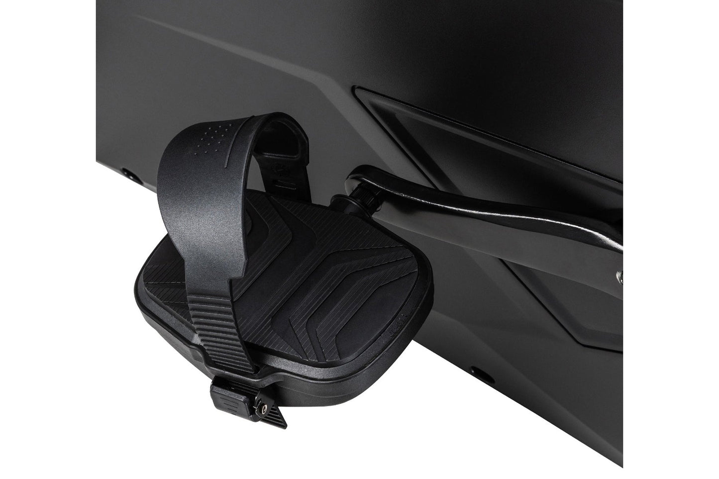 Black stationary bike pedal with textured footplate and adjustable strap attached to exercise equipment