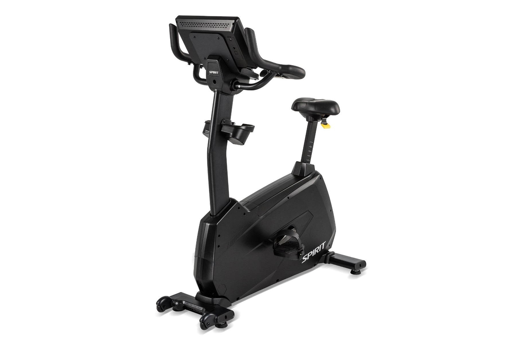 Black upright exercise bike with digital console, padded seat, handlebars, and foot pedals on white background