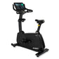 Spirit CU1000ENT black upright stationary exercise bike with digital display console and yellow handlebar accents, on white b